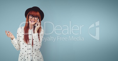 Happy woman talking on the phone against blue background