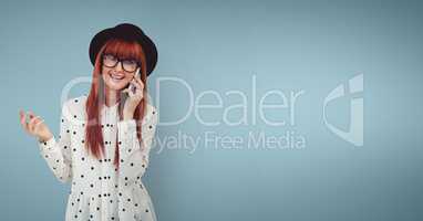 Happy woman talking on the phone against blue background