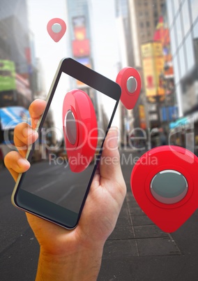 Holding phone and Location pointer markers in city street
