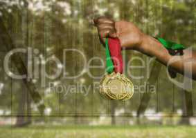 Hand holding medals with green transparent nature
