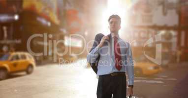 Business man standing against city background