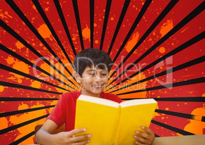 Happy boy reading against red, black and orange splattered background