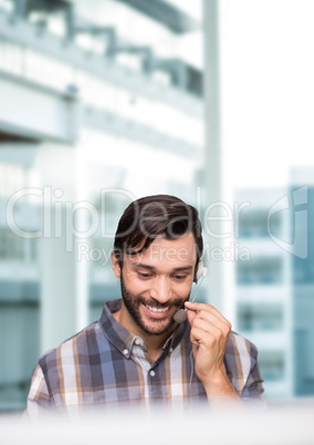 Happy customer care representative man against city background