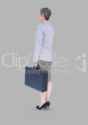 Full body portrait of businesswoman standing with grey background