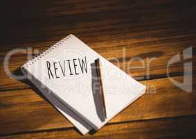 Review  text written on page with wood