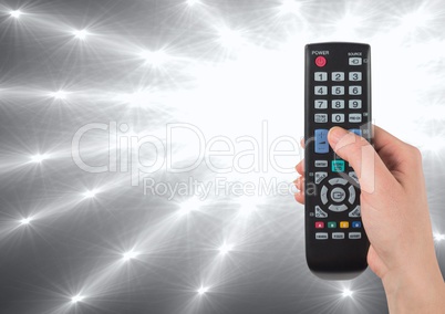 TV remote control with bright light shining out of dark