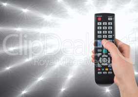 TV remote control with bright light shining out of dark
