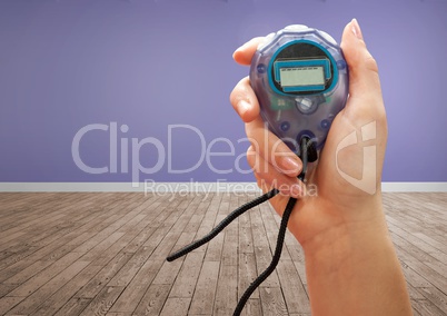 Hands holding stopwatch timer in purple room