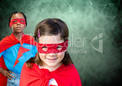 Superhero kids in front of green background