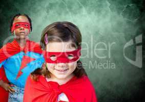 Superhero kids in front of green background
