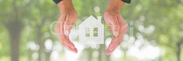 Hands holding a house icon as house insurance concept