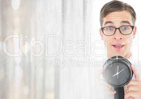 man holding clock in front of bright light