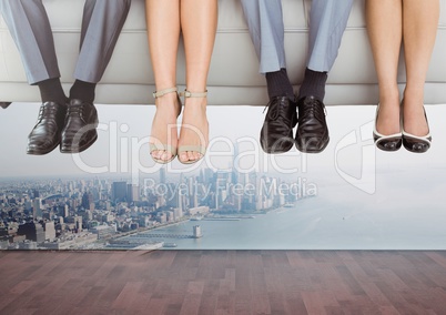 People's feet hanging off floating couch over city
