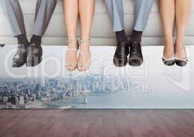 People's feet hanging off floating couch over city