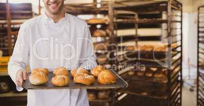 Happy small business owner man holding bread