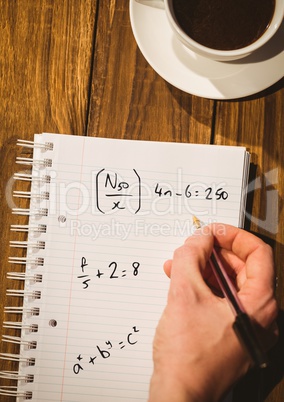 Hand writing math sums on notepad
