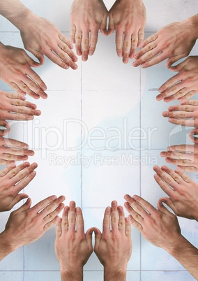 Hands together in circle over tiles