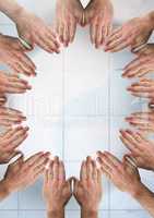 Hands together in circle over tiles