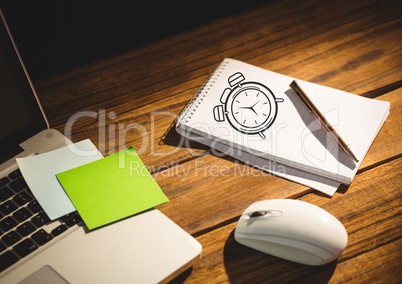 Clock drawing of time on notepad with laptop