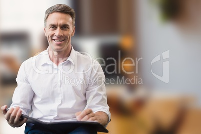 Business man holding files against office background
