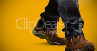 Hiking boots over yellow background