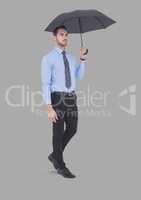 Full body portrait of man holding umbrella standing with grey background