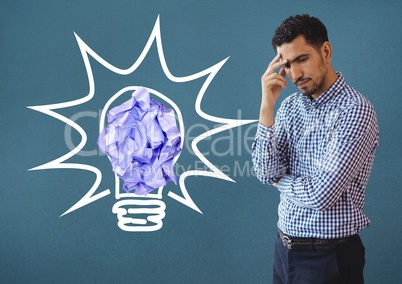 Man standing next to light bulb with crumpled paper ball