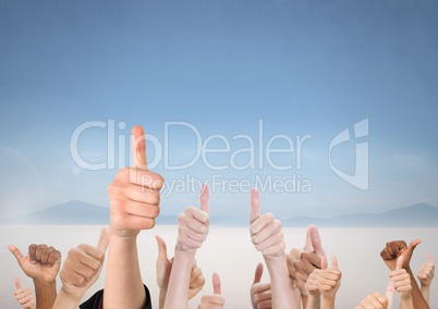 Lots of hands liking thumbs up with blue sky