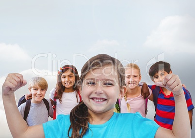 Girl flexing muscles with friends in front of grey background