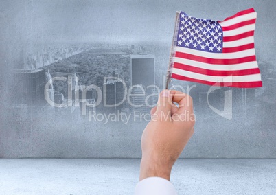 Hand holding American flag in city