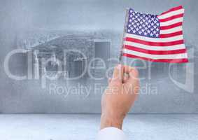 Hand holding American flag in city