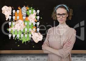 Woman standing next to light bulbs with crumpled paper balls in front of blackboard