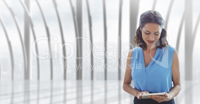 Business woman using a tablet against building background