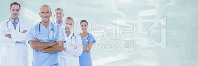 Doctors standing against green background