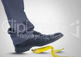 Man stepping on banana skin with black shoe