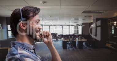 Happy customer care representative man against office background