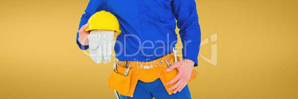 Plumber man holding globes and a helmet against yellow background