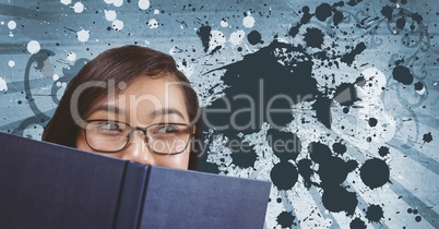 Young student woman reading against blue splattered background