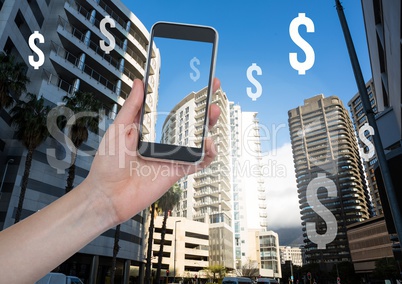 Holding phone and Dollar icons in financial district skyscrapers city