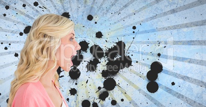 Surprised young student woman standing against blue splattered background