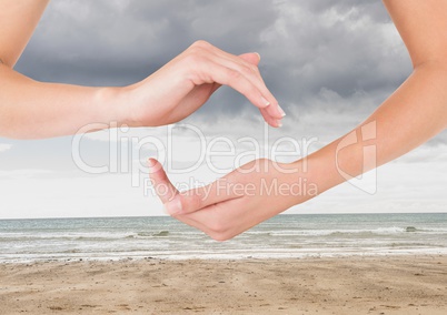 Arms posing in unison at tranquil sea sky