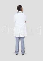 Full body portrait of doctor man standing with grey background