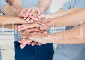 Lots of hands together with sea background