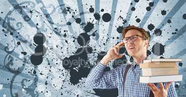 Confused young student man holding books against blue splattered background