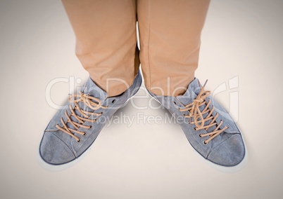 Feet and shoes on grey background