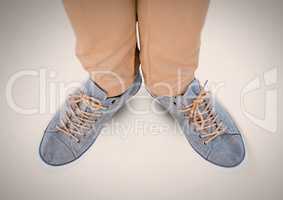 Feet and shoes on grey background