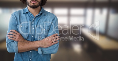 Business man standing against office background