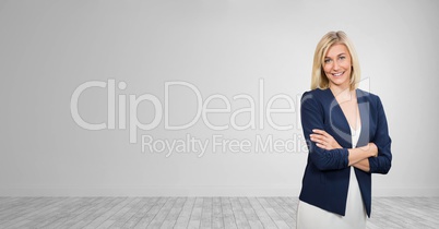 Happy business woman standing against white wall background