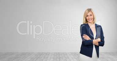 Happy business woman standing against white wall background