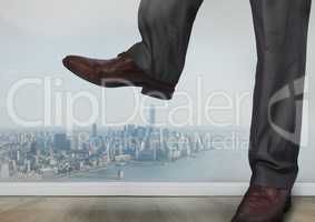 Businessman's feet and shoes stamping on city